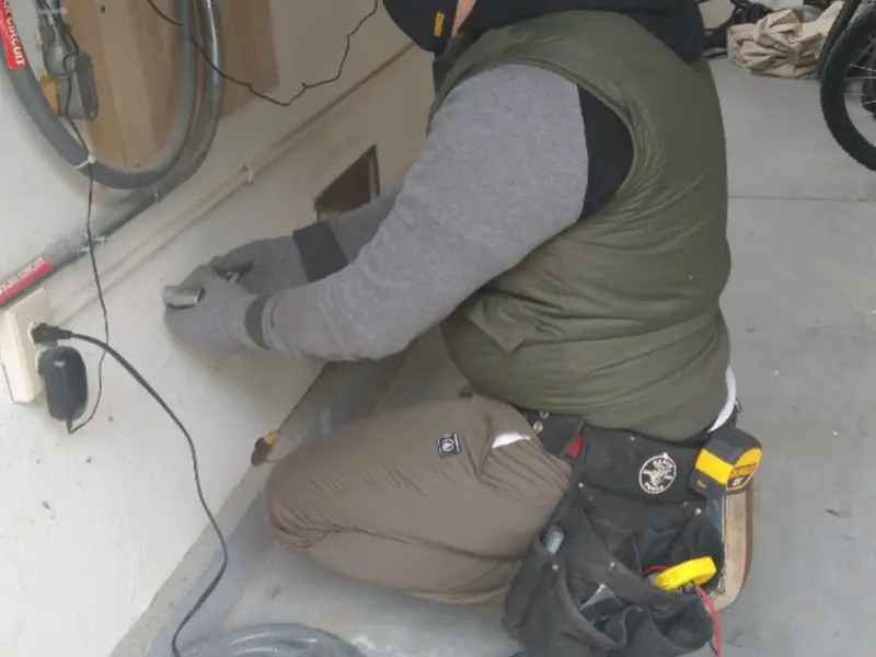 Electrician performing outlet wiring in a Golf Manor garage